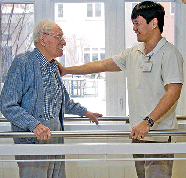 Physical Therapist Assisting a Senior Man