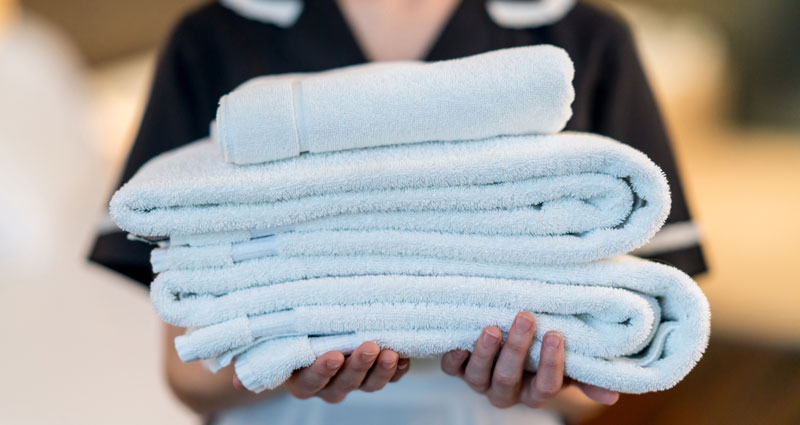 Woman holding folded towels