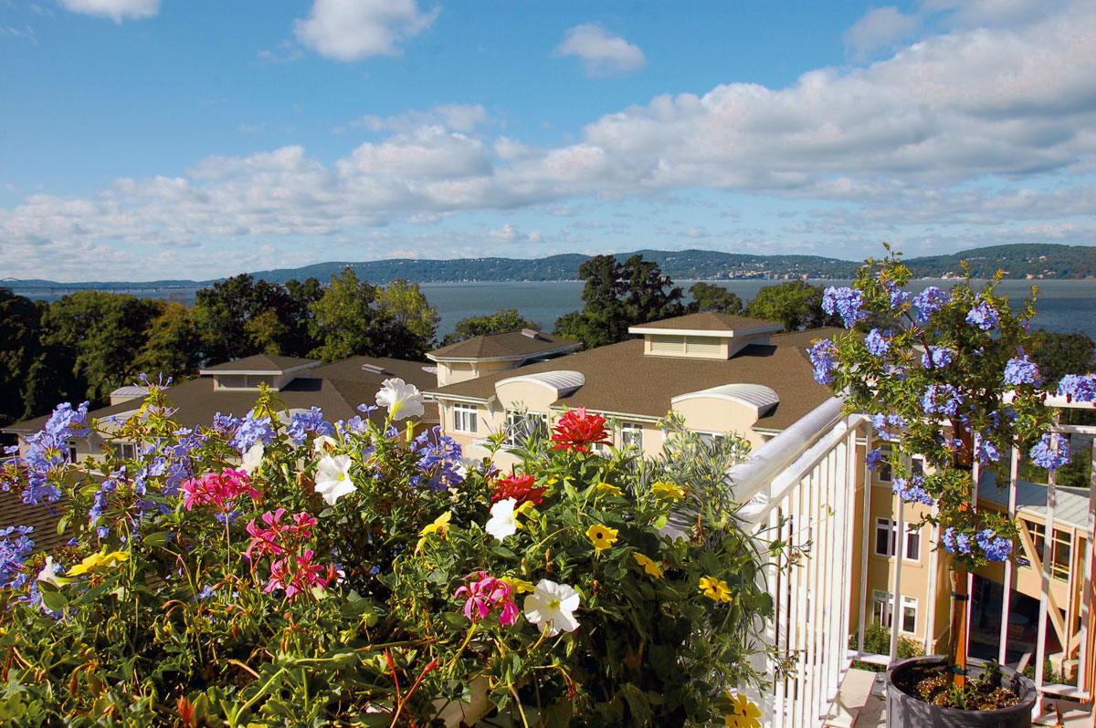View off balcony with flowers and Hudson River in the background