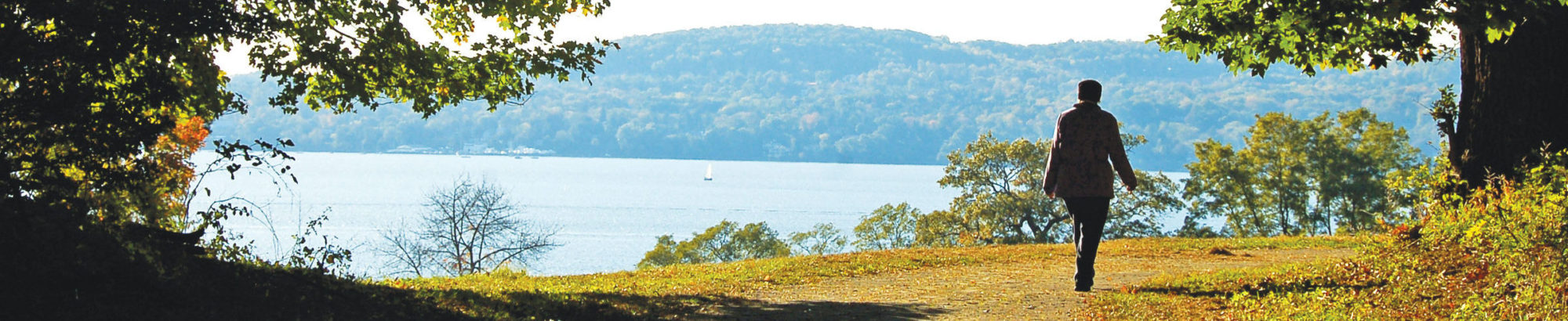 Person walking outside with Hudson River in the background