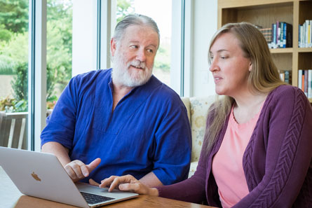 Life Plan community Resident and young woman over computer