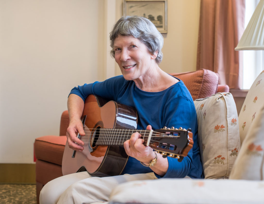 Resident playing guitar