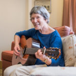 Senior woman playing guitar