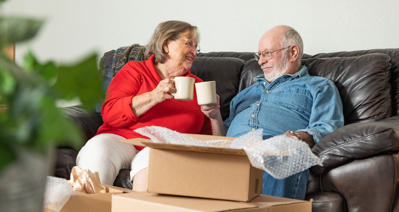 couple enjoying coffee while packing