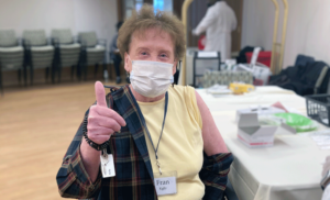 Kendal on Hudson resident Fran Kelly smiles behind her mask after getting vaccinated.