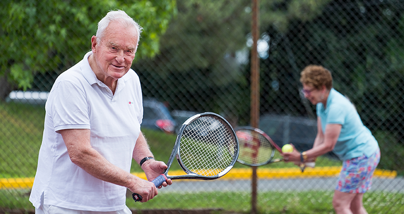 senior playing tennis