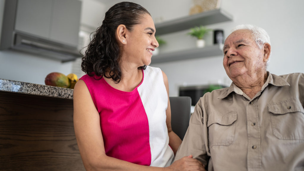 Senior man and his daughter talking at home