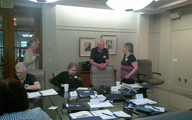 group of seniors gathered around a conference table