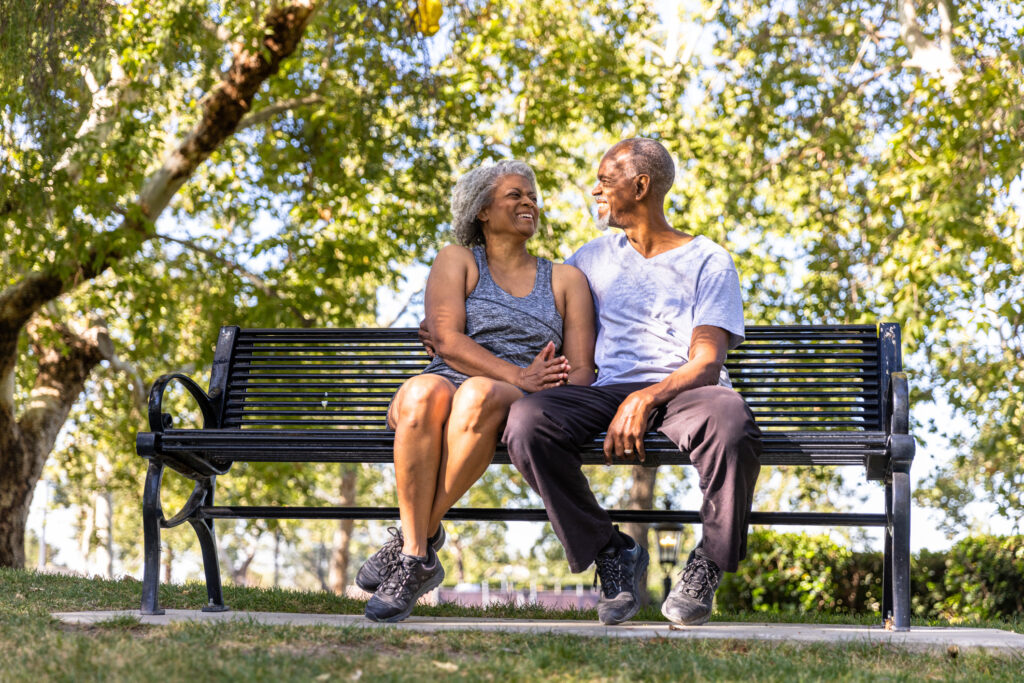 A senior couple sitting and relaxing together at the park