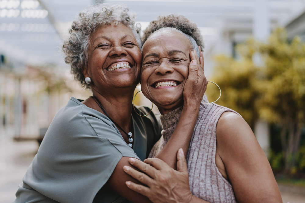 Portrait of two senior friends hugging