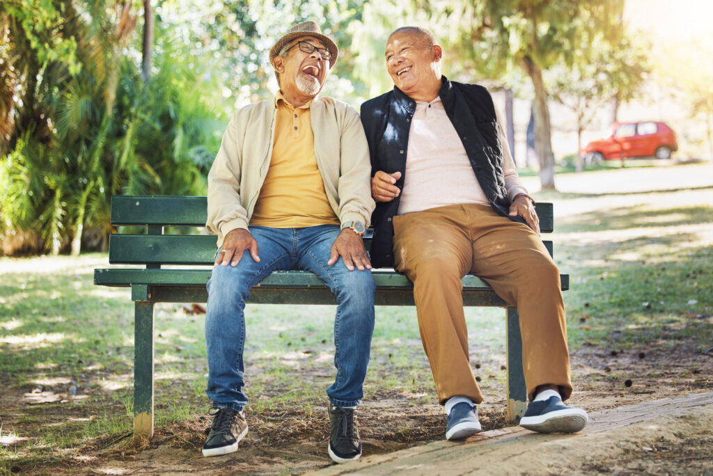 two senior men sitting on bench