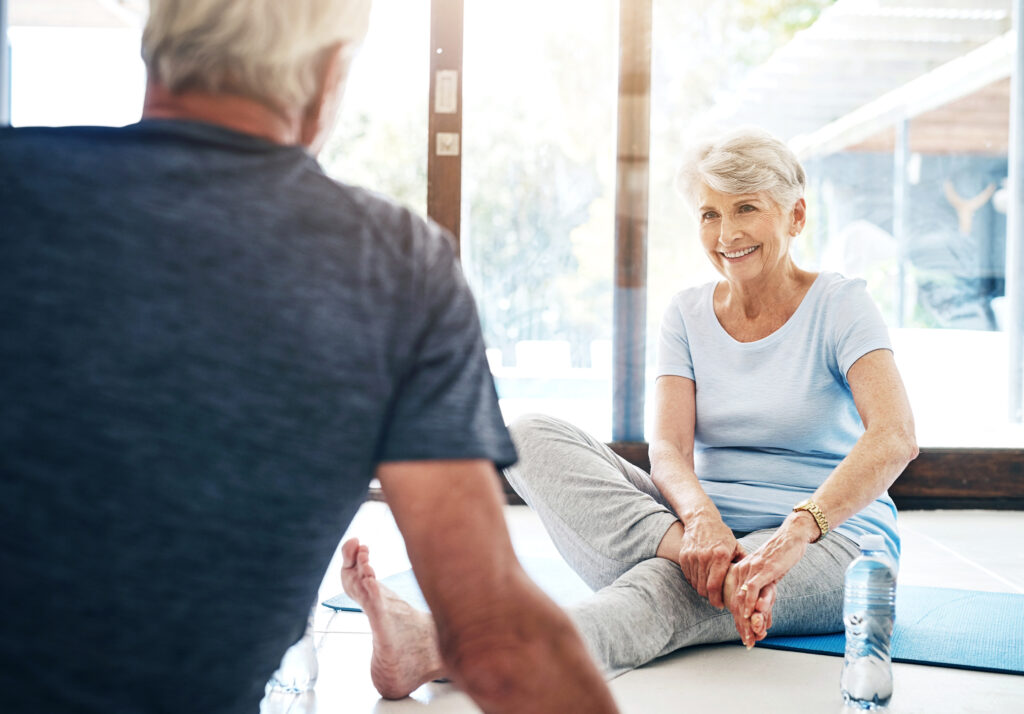 senior woman and man stretching