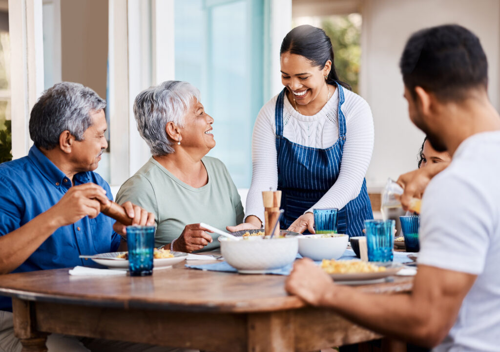 seniors enjoying meal with family members, happy they took the time for post-retirement planning